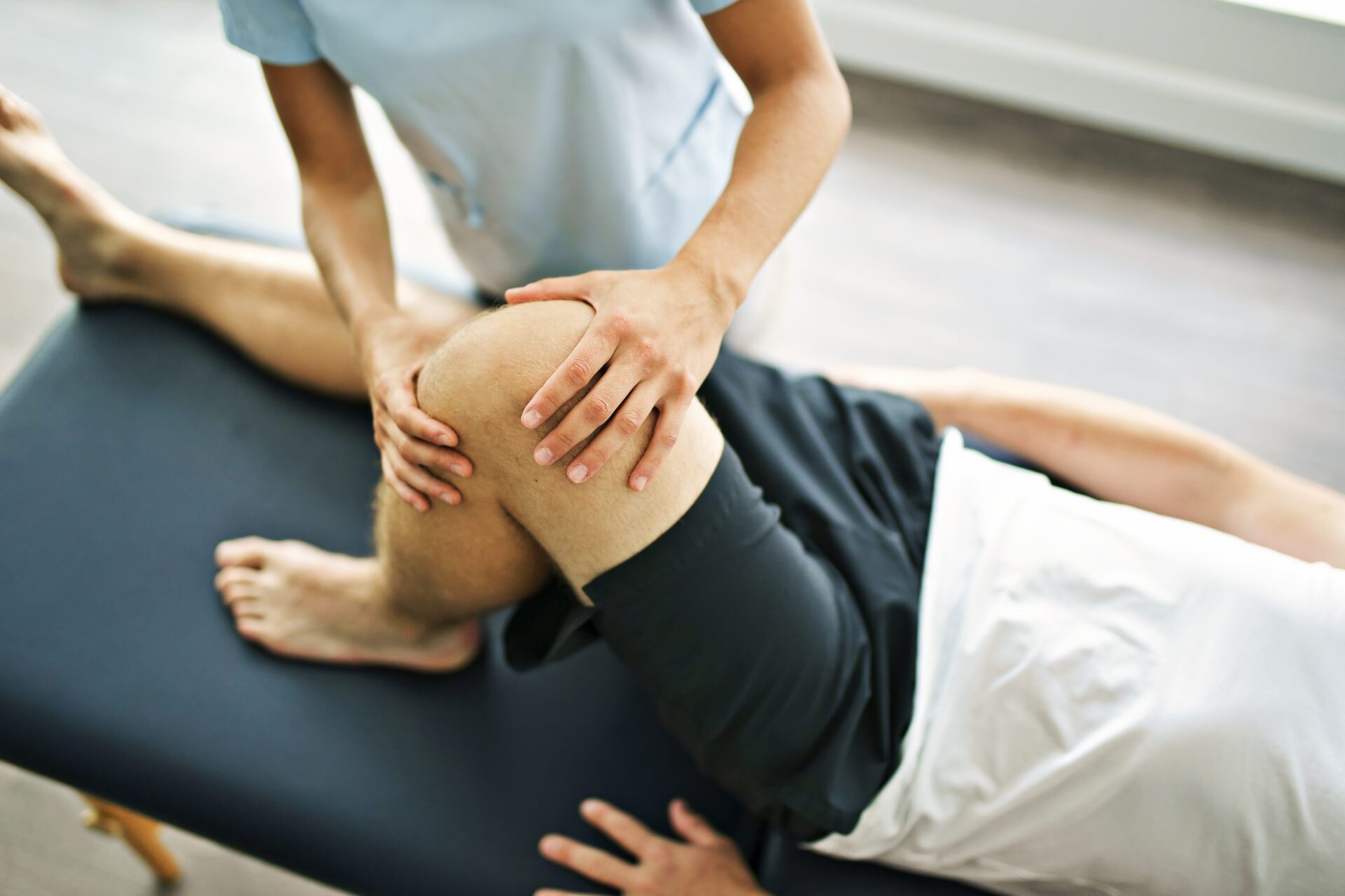 physiotherapist doing treatment with patient in bright office